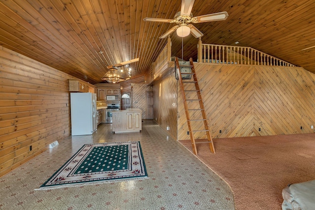 interior space featuring wood walls, wood ceiling, lofted ceiling, and a ceiling fan