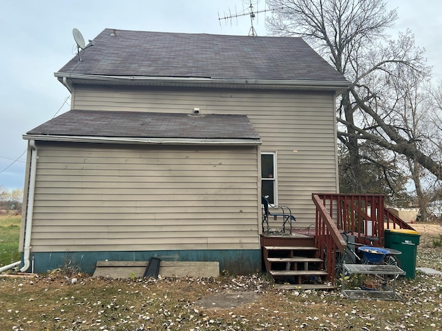 view of home's exterior with a wooden deck