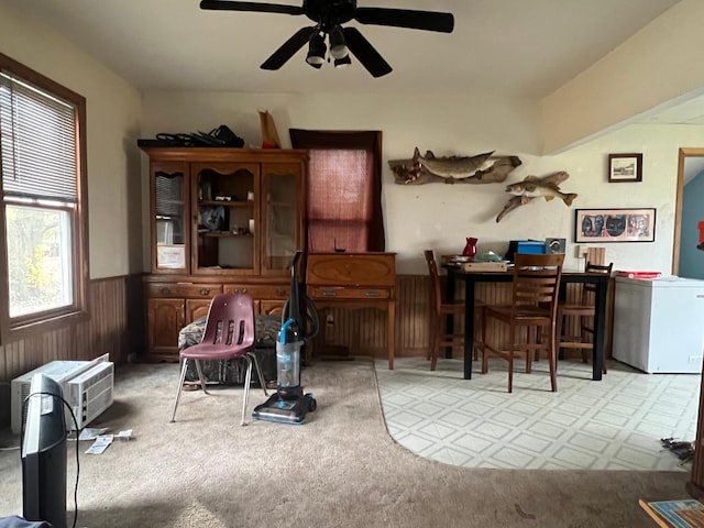 dining area with light colored carpet and ceiling fan