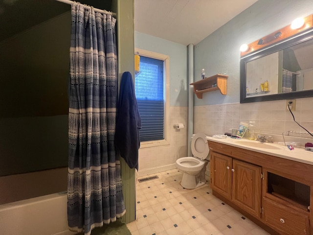 full bathroom with vanity, toilet, tile walls, and shower / bath combination with curtain