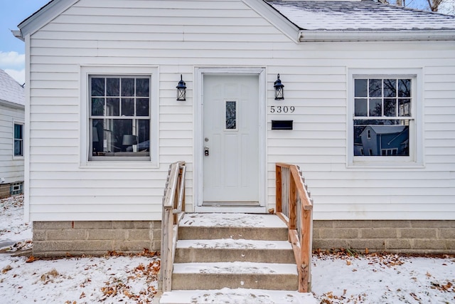 view of snow covered property entrance