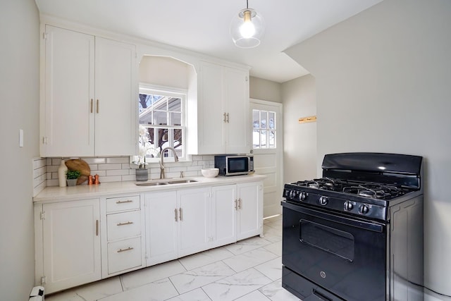 kitchen with white cabinets, black gas stove, and sink