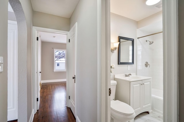 bathroom with wood-type flooring, vanity, and toilet