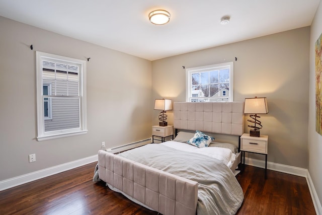 bedroom featuring baseboard heating and dark wood-type flooring