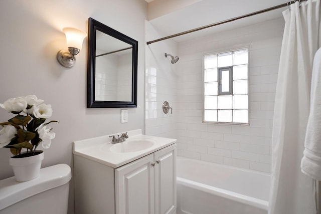 full bathroom featuring shower / bath combo, vanity, and toilet