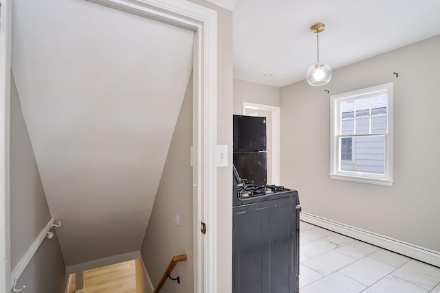 kitchen with black refrigerator, range, and a baseboard heating unit