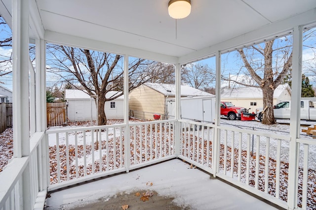 snow covered patio featuring a porch