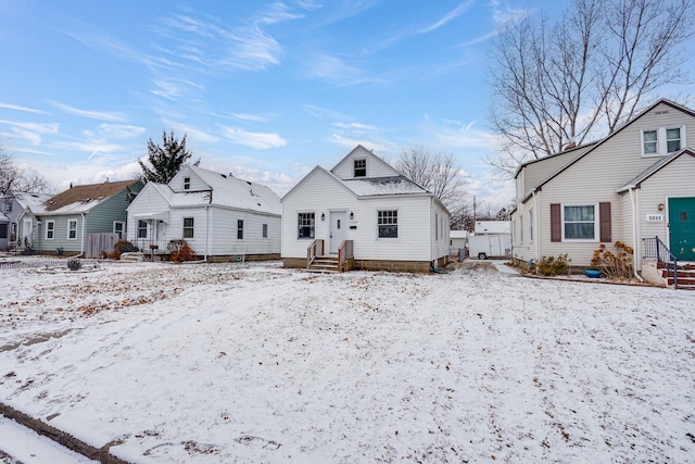 view of snow covered back of property