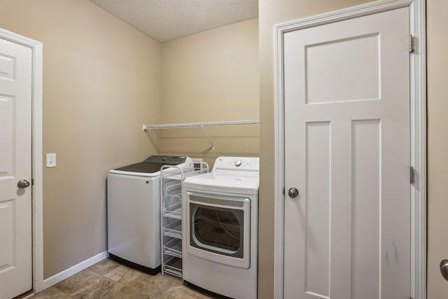 laundry room featuring independent washer and dryer and a textured ceiling