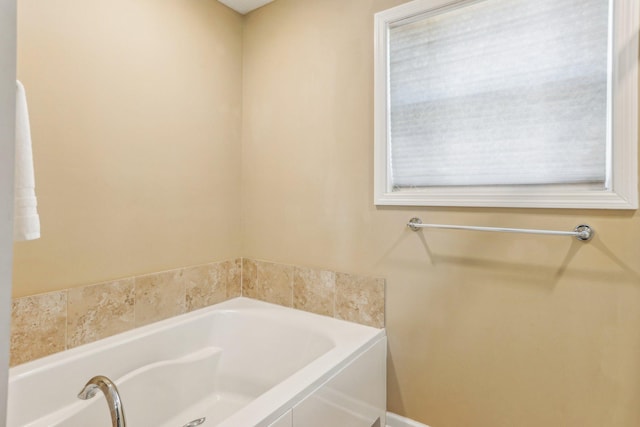 bathroom with a tub to relax in