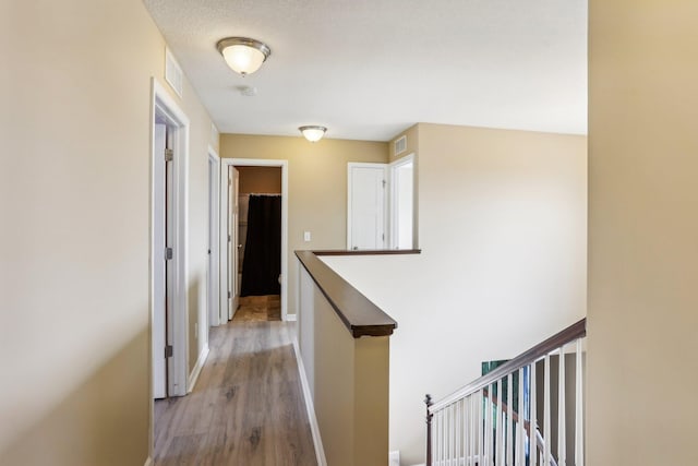 corridor with light hardwood / wood-style floors