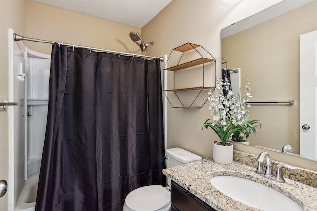 bathroom with vanity, a shower with shower curtain, a textured ceiling, and toilet