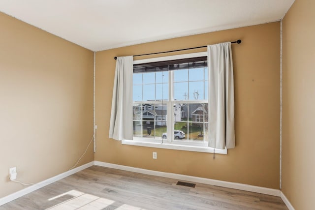 spare room featuring light hardwood / wood-style floors