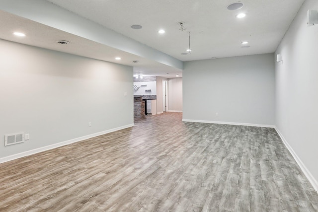 unfurnished living room featuring light wood-type flooring