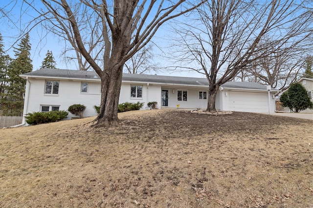 ranch-style home featuring fence, an attached garage, driveway, and brick siding