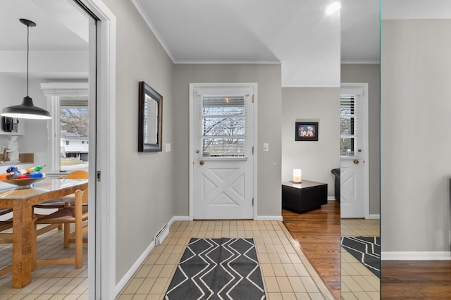 entryway with crown molding, baseboards, and light wood-type flooring