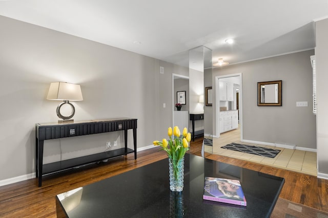 interior space with baseboards and wood finished floors