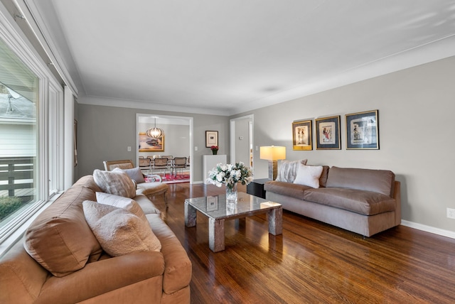 living area featuring baseboards and wood finished floors