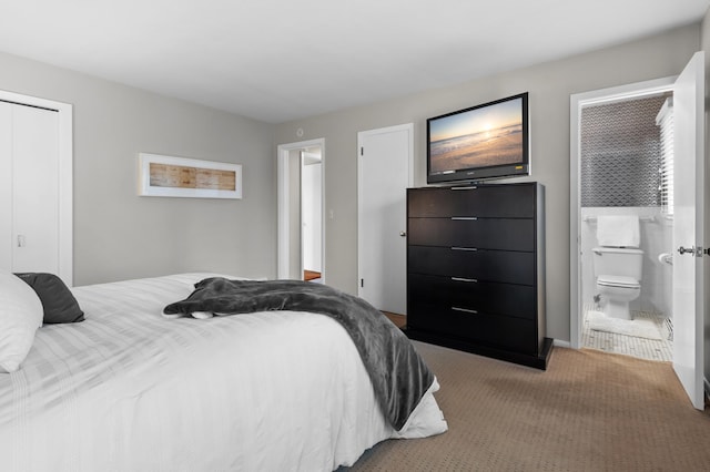 bedroom with a closet, carpet, and ensuite bathroom