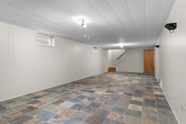 basement with stone tile floors and stairs