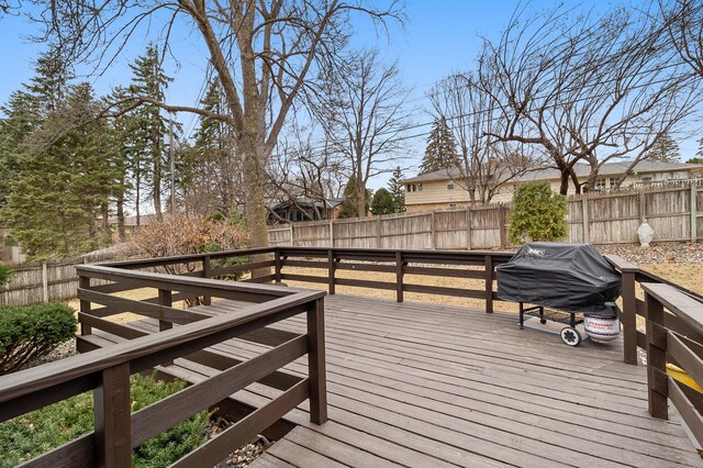 deck featuring a fenced backyard and grilling area