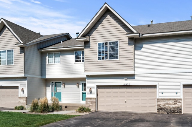 townhome / multi-family property featuring a garage