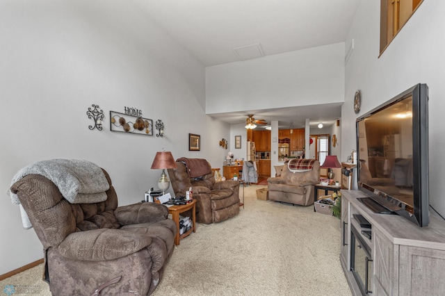 carpeted living room featuring a high ceiling and ceiling fan