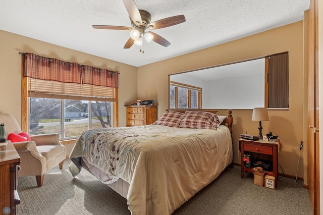 carpeted bedroom with a textured ceiling and ceiling fan