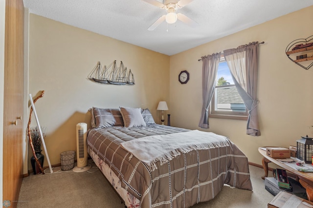 bedroom with a textured ceiling, carpet, and ceiling fan