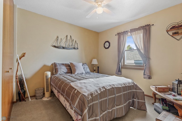 bedroom with carpet, baseboards, a ceiling fan, and a textured ceiling