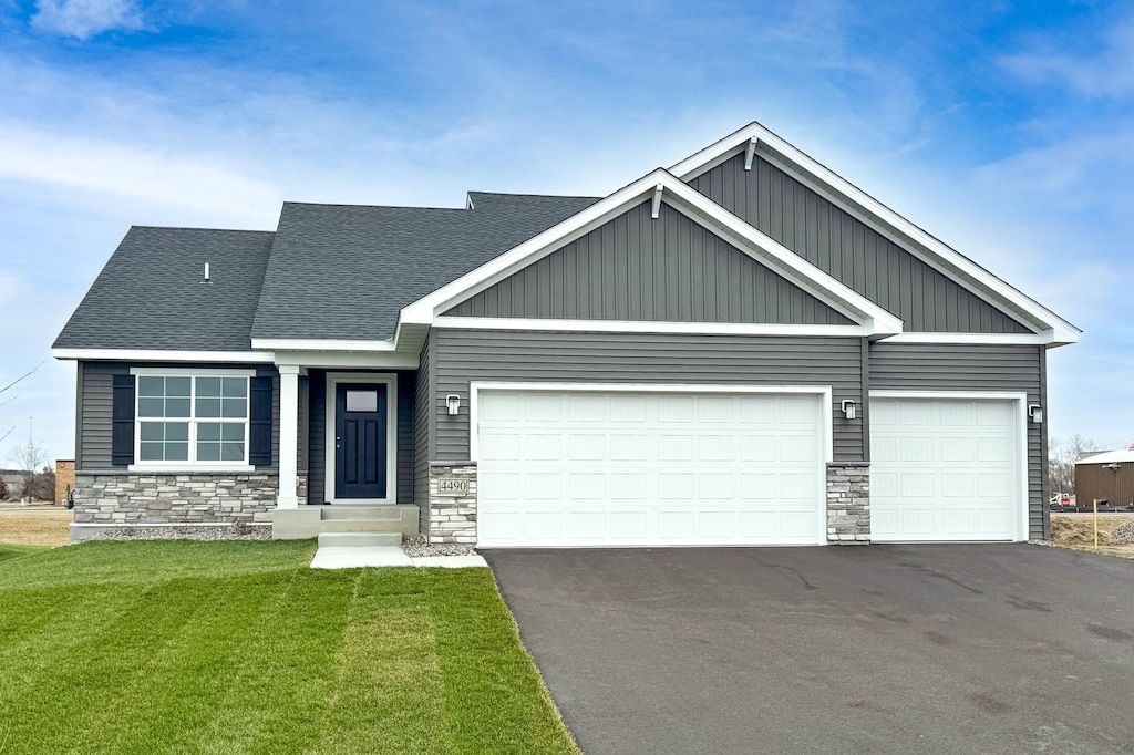 craftsman-style home featuring a garage and a front lawn