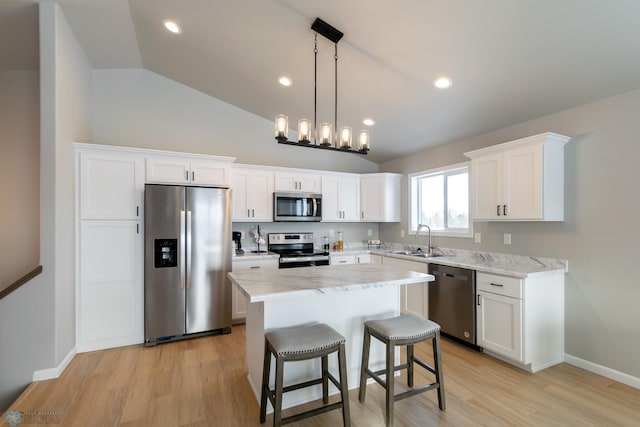 kitchen with white cabinetry, sink, a kitchen island, and stainless steel appliances