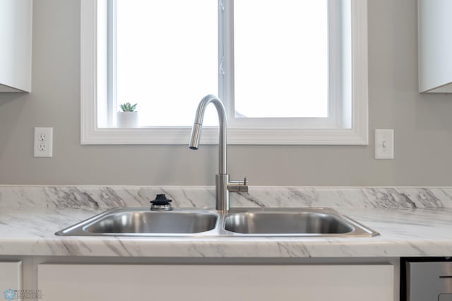 room details with white cabinetry and sink