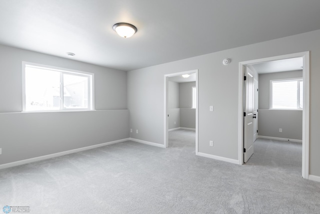 unfurnished bedroom featuring light carpet