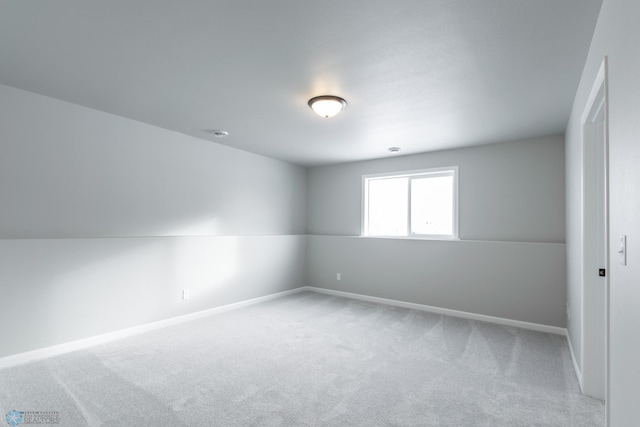 unfurnished room featuring light colored carpet