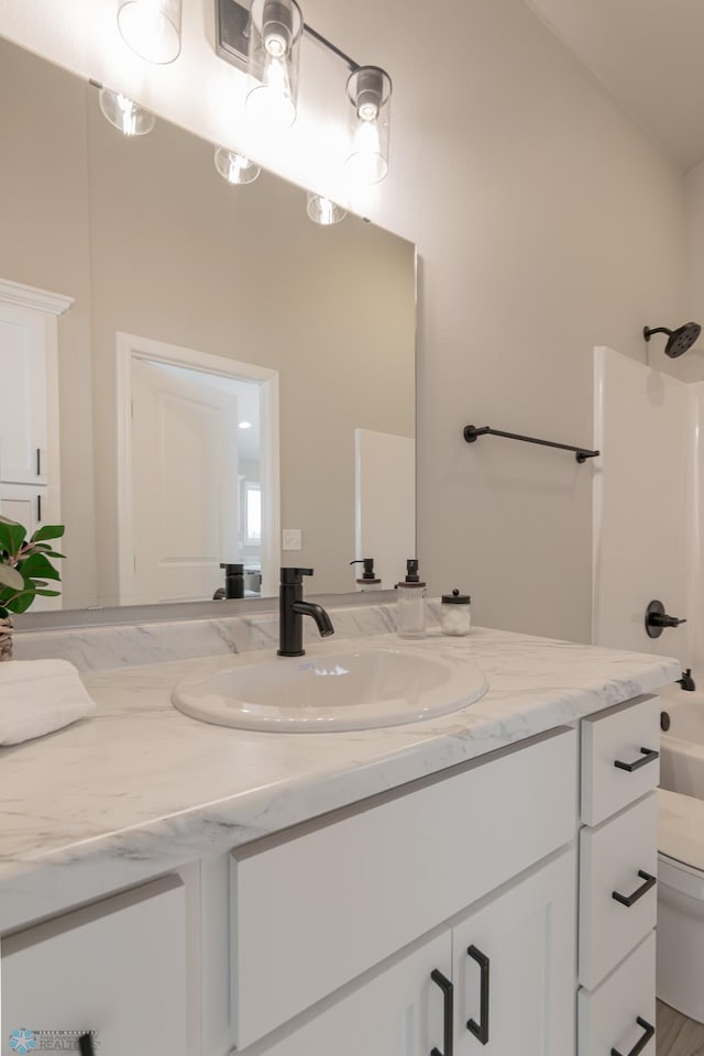 full bathroom featuring vanity, toilet, shower / washtub combination, and vaulted ceiling