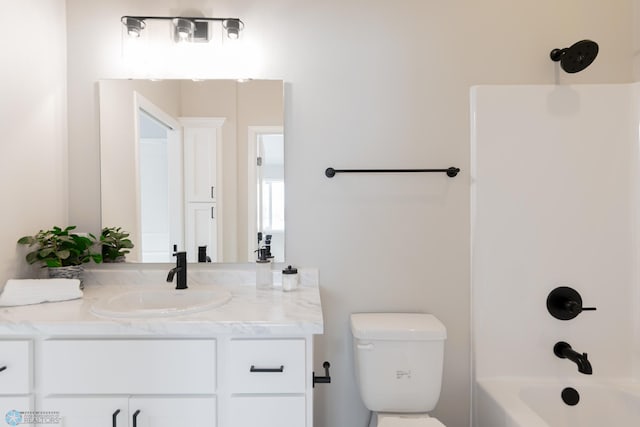 full bathroom featuring bathing tub / shower combination, vanity, and toilet