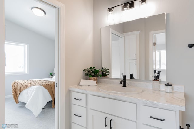 bathroom with vanity and vaulted ceiling