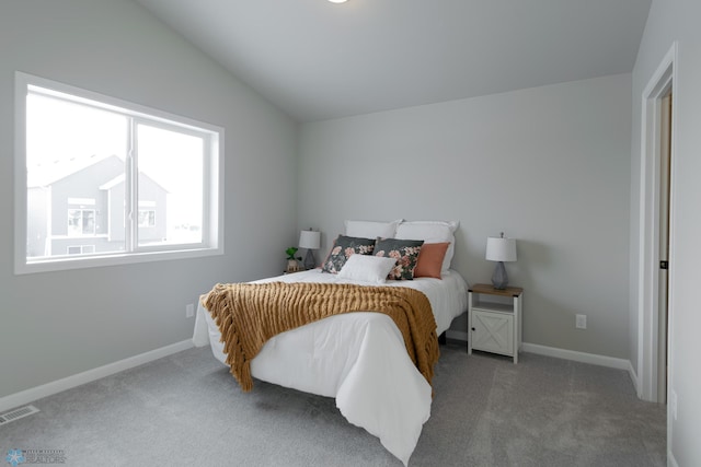 bedroom featuring carpet flooring and vaulted ceiling