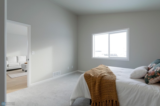 carpeted bedroom featuring vaulted ceiling