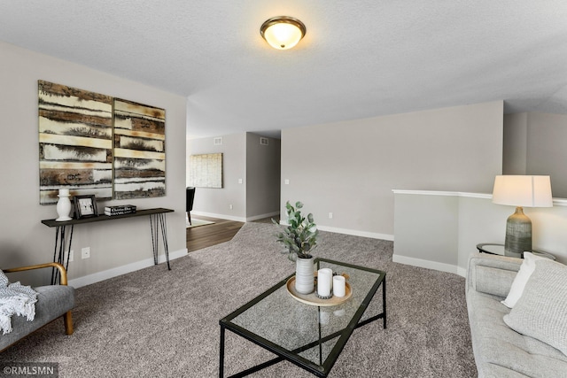 carpeted living room featuring a textured ceiling