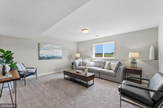 carpeted living room featuring a textured ceiling