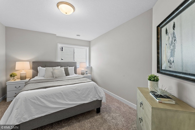 carpeted bedroom featuring a textured ceiling