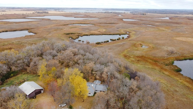 birds eye view of property with a water view and a rural view