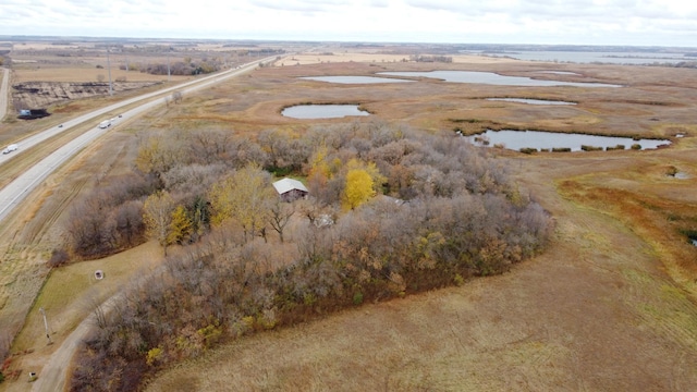 drone / aerial view featuring a water view and a rural view