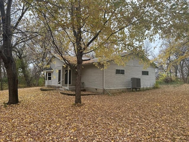 rear view of property with central AC