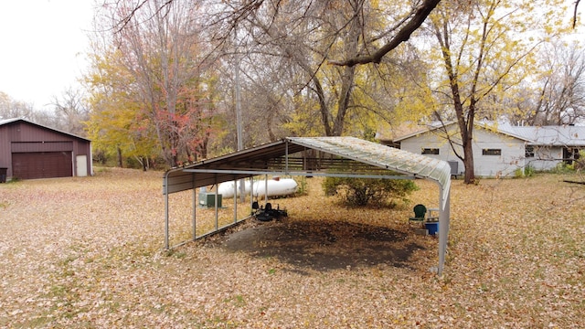 view of yard with an outdoor structure, a garage, and a carport