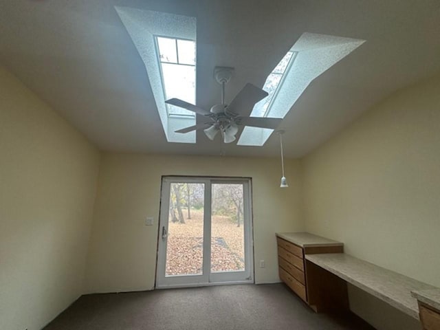 additional living space with ceiling fan, light carpet, and a skylight