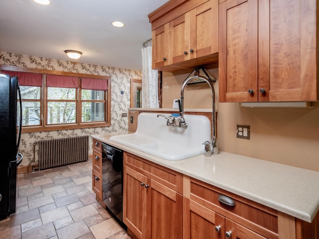 kitchen with sink, black appliances, and radiator heating unit