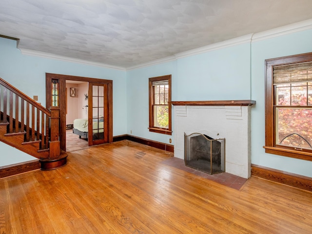 unfurnished living room with ornamental molding, light hardwood / wood-style flooring, and a fireplace